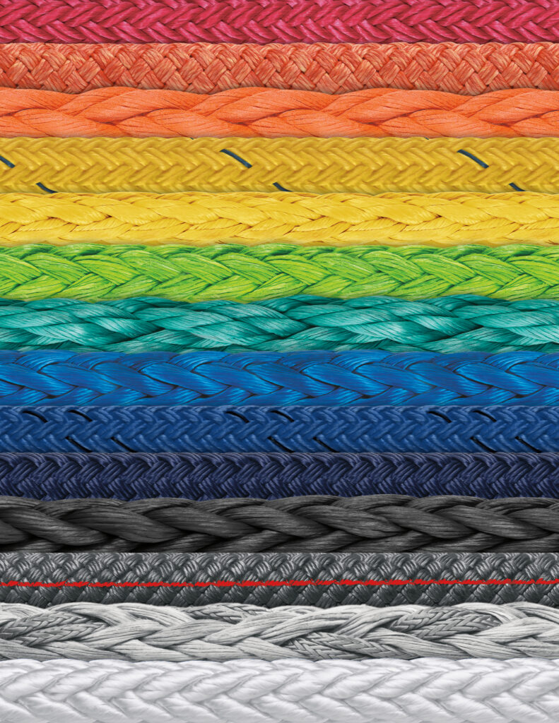 close up of braded ropes of many colors laid out in a rainbow pattern